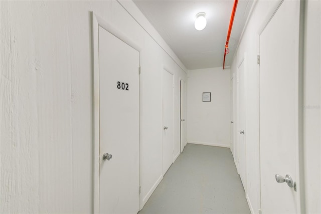 hallway featuring finished concrete flooring