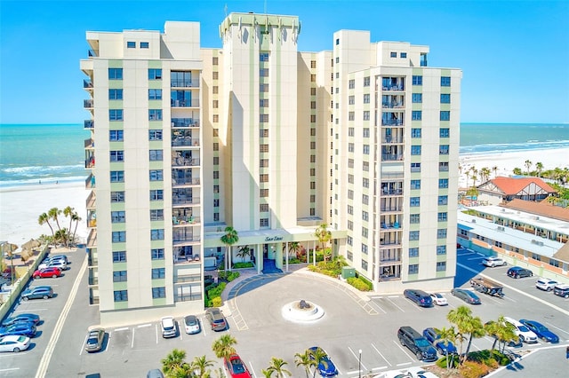 view of property with a view of the beach and a water view