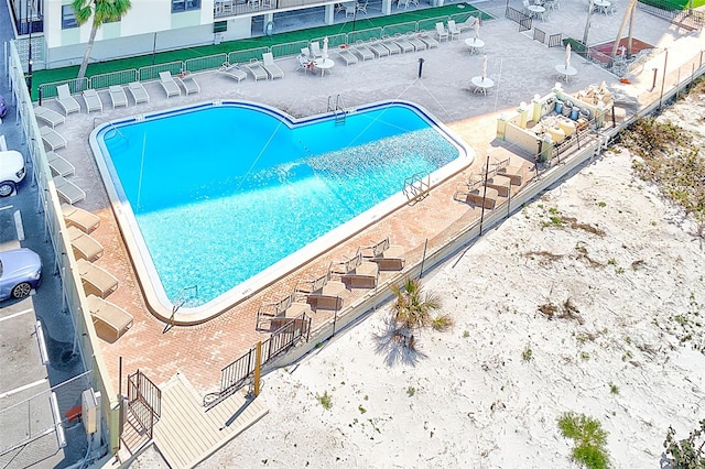 pool featuring a patio and fence