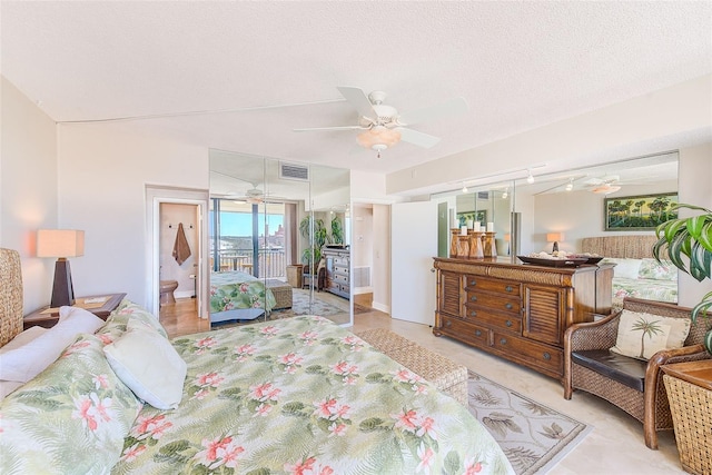 bedroom featuring visible vents, access to outside, a textured ceiling, rail lighting, and ceiling fan