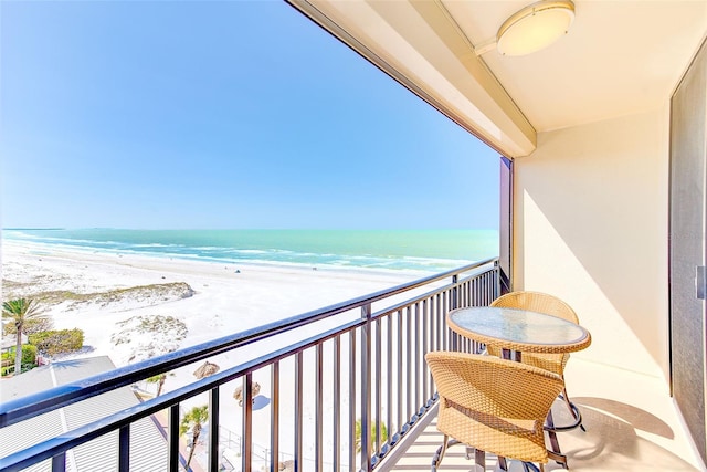 balcony with a beach view and a water view