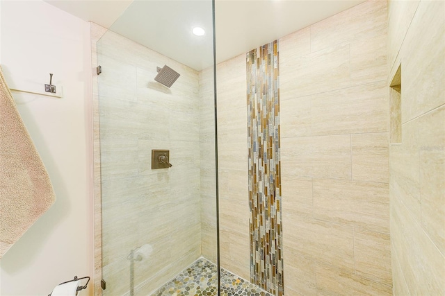 full bath with a tile shower