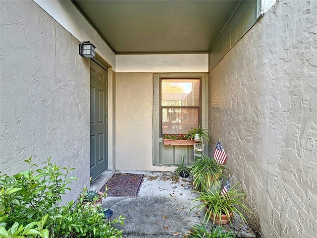 property entrance with stucco siding