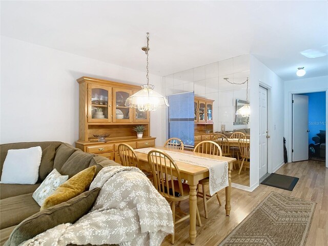 dining room with an inviting chandelier and light wood finished floors