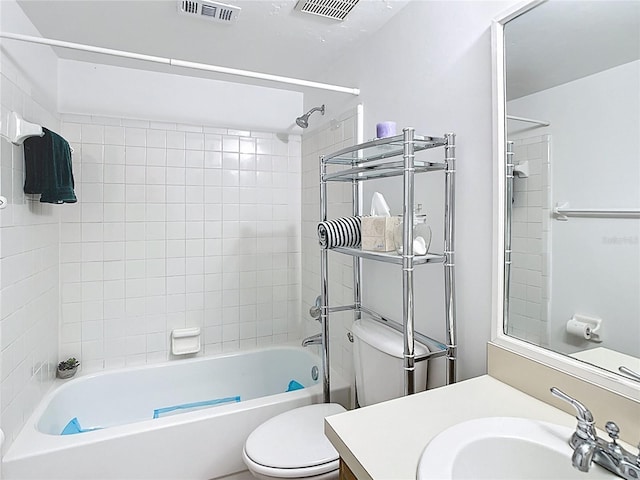 bathroom with visible vents, toilet, vanity, and bathtub / shower combination