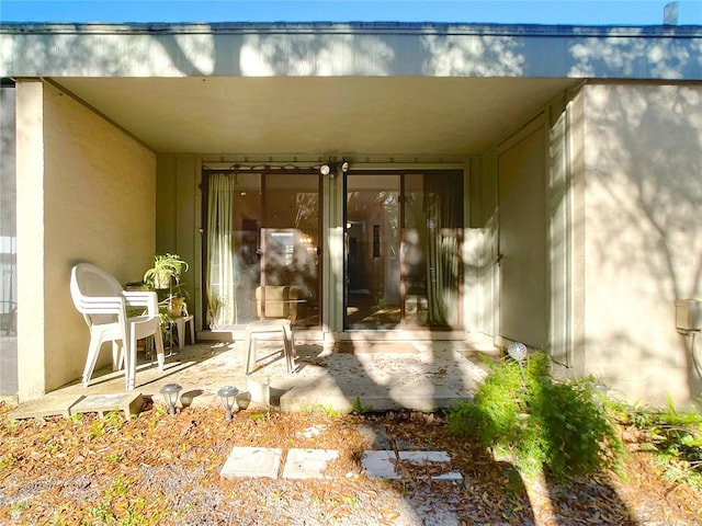 doorway to property with stucco siding