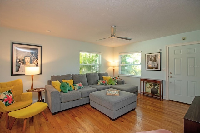 living area featuring a ceiling fan and light wood-style floors