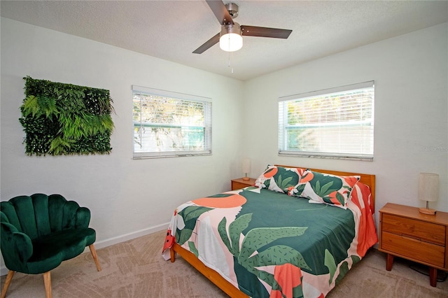 bedroom with a textured ceiling, a ceiling fan, baseboards, and carpet floors