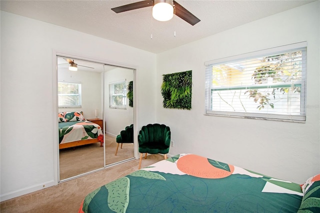 bedroom featuring a closet, carpet floors, multiple windows, and a textured ceiling