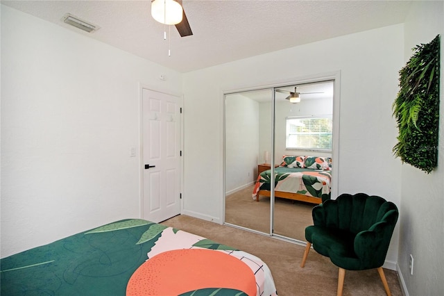 bedroom with a closet, baseboards, visible vents, and carpet floors