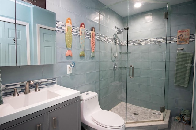 bathroom featuring tile walls, toilet, a stall shower, and backsplash