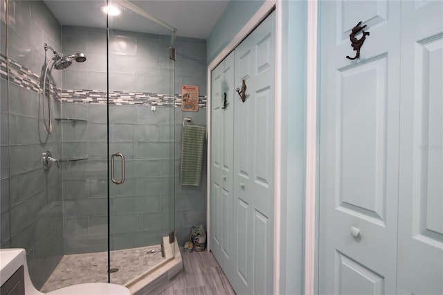 full bathroom with a shower stall, toilet, and vanity