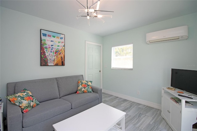 living room featuring baseboards, a notable chandelier, and an AC wall unit