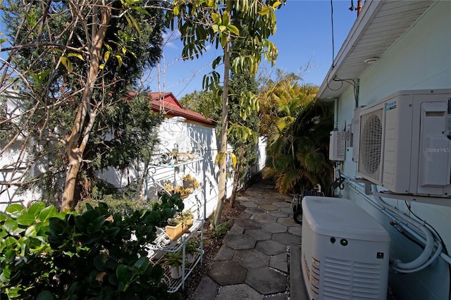 view of property exterior with fence, a patio, and ac unit