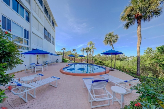 pool featuring a patio area and fence