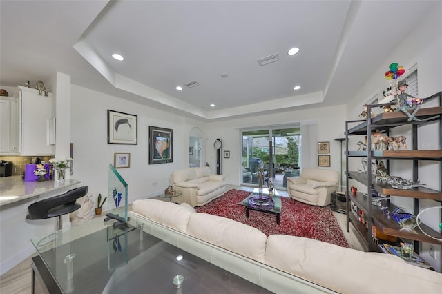 807 Chipper Dr, Sun City Center, FL 33573 - living area featuring a raised ceiling, recessed lighting, visible vents, and arched walkways