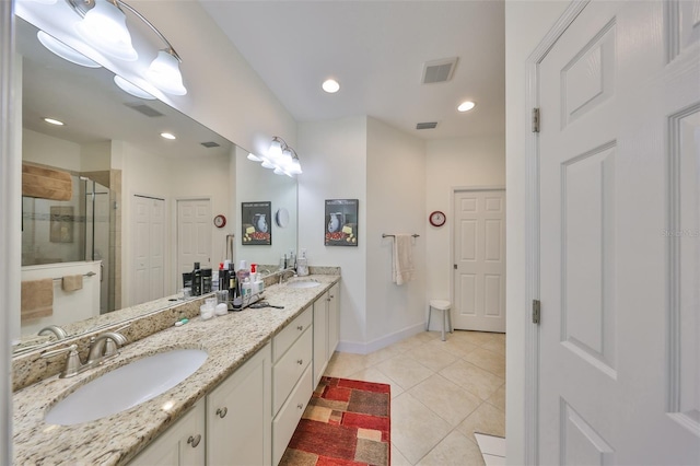 807 Chipper Dr, Sun City Center, FL 33573 - full bathroom with a sink, visible vents, a stall shower, and tile patterned flooring