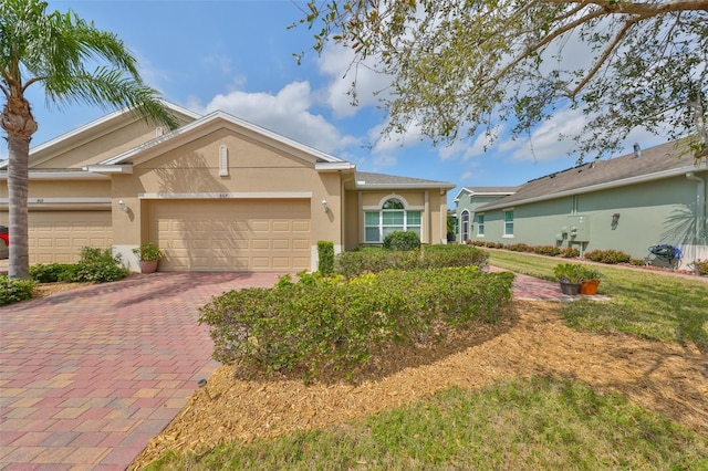 807 Chipper Dr, Sun City Center, FL 33573 - single story home with decorative driveway, a garage, and stucco siding