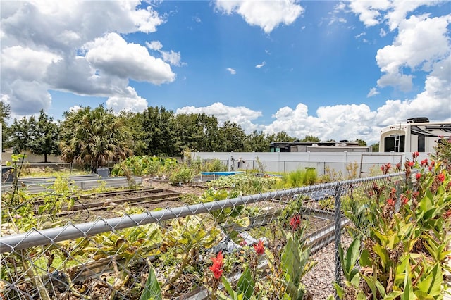 view of yard featuring a vegetable garden and fence