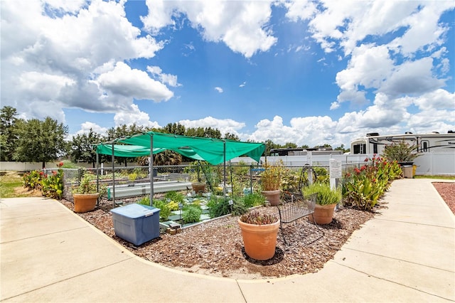 exterior space featuring a vegetable garden and fence