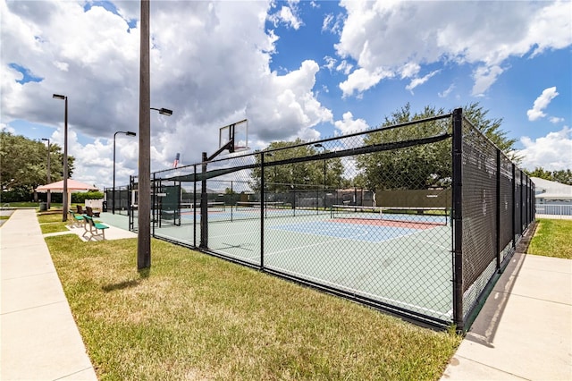 view of basketball court featuring community basketball court, fence, a lawn, and a tennis court