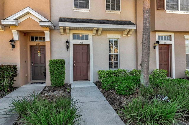 property entrance featuring stucco siding