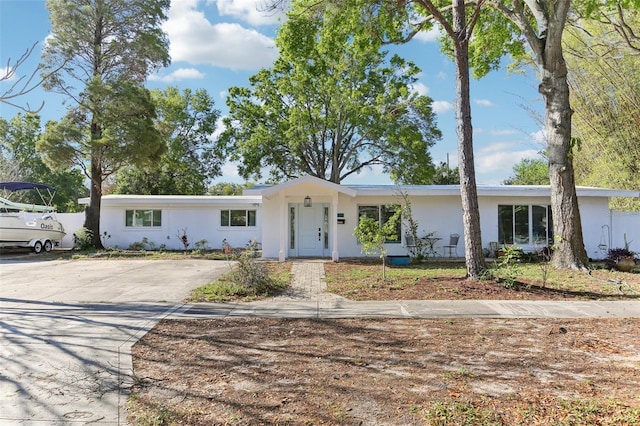 single story home with stucco siding and driveway