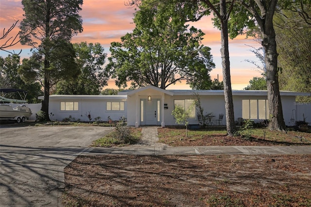 view of front facade featuring concrete driveway and stucco siding