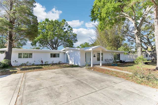 single story home featuring stucco siding and concrete driveway