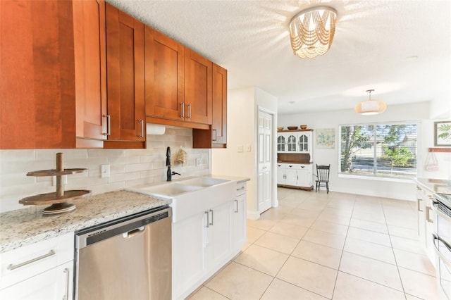 kitchen featuring a sink, tasteful backsplash, stainless steel dishwasher, an inviting chandelier, and light tile patterned floors