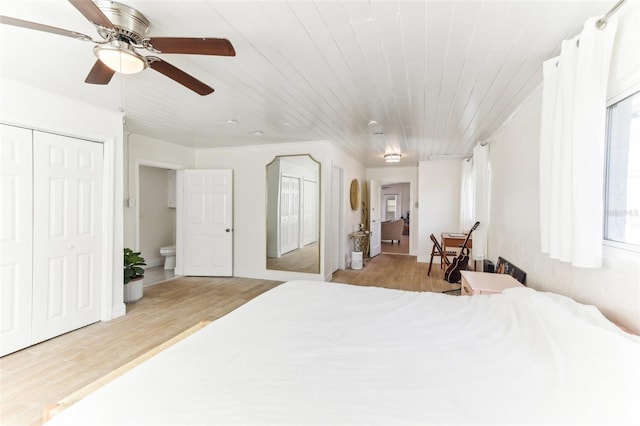 bedroom with ceiling fan, wood finished floors, and wooden ceiling