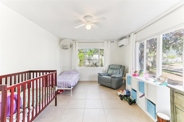 bedroom with a wall mounted air conditioner, light tile patterned flooring, and a ceiling fan