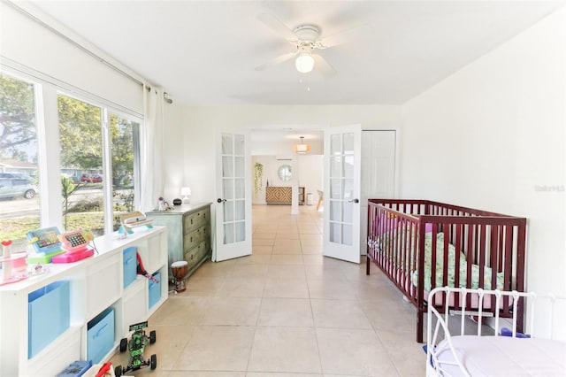 bedroom featuring light tile patterned floors, french doors, and ceiling fan