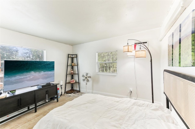 bedroom featuring baseboards and wood finished floors