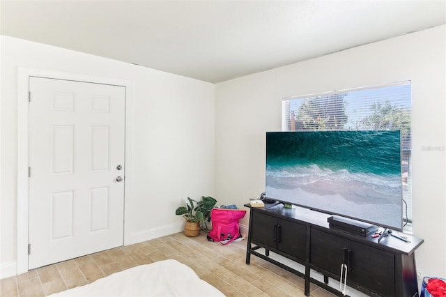 interior space with baseboards and wood finish floors