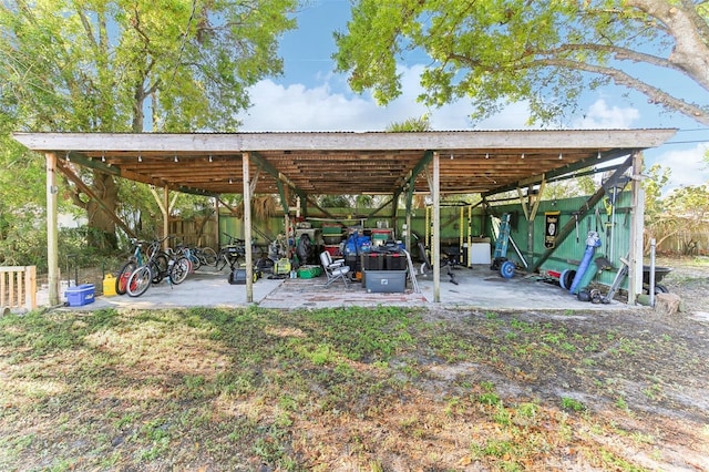 view of vehicle parking featuring a carport and a pole building