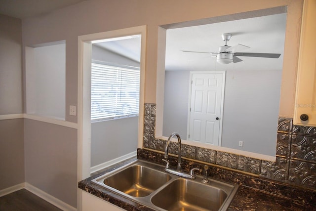 interior details with a ceiling fan, baseboards, and a sink