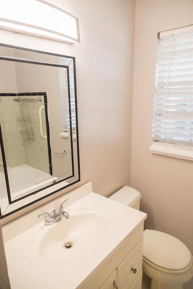 full bath featuring a shower, toilet, and vanity