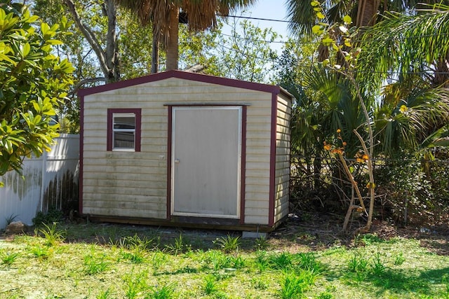 view of shed featuring fence