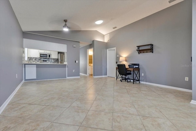 unfurnished living room with tile patterned flooring, visible vents, ceiling fan, baseboards, and high vaulted ceiling