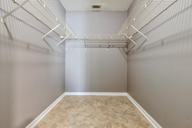 walk in closet featuring tile patterned flooring