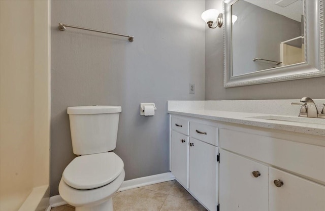 bathroom with tile patterned floors, baseboards, toilet, and vanity