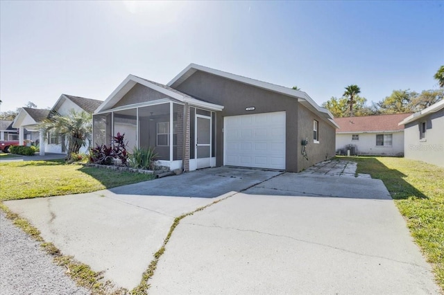 ranch-style home featuring a garage, a front lawn, and stucco siding