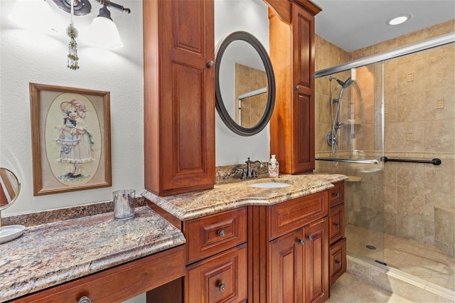 full bath with a stall shower and vanity