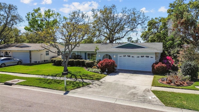 ranch-style house with an attached garage, driveway, and a front lawn