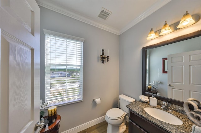 half bath featuring visible vents, crown molding, baseboards, toilet, and vanity