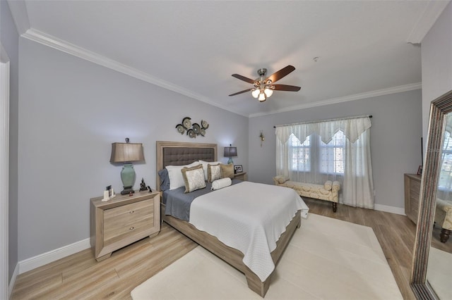 bedroom featuring crown molding, light wood-type flooring, and baseboards