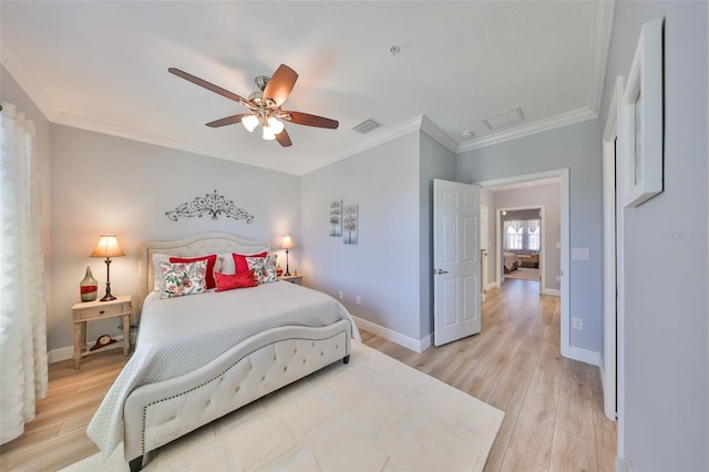 bedroom with visible vents, crown molding, baseboards, light wood-type flooring, and a ceiling fan