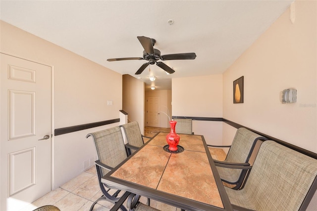 dining area with light tile patterned flooring and a ceiling fan