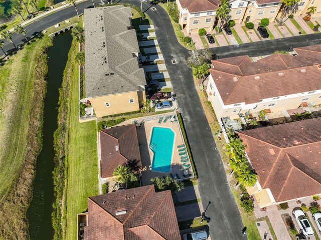 drone / aerial view with a residential view and a water view